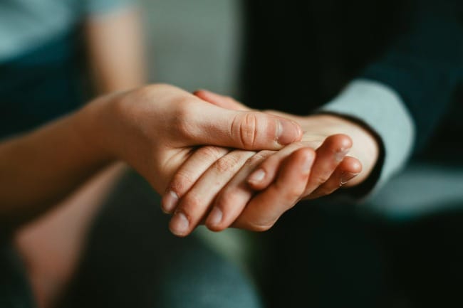 person holding babys hand