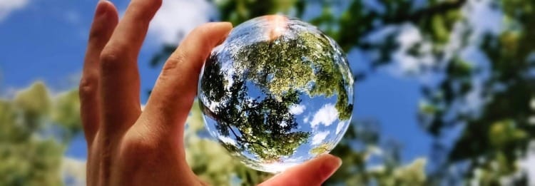 unknown person holding clear glass ball